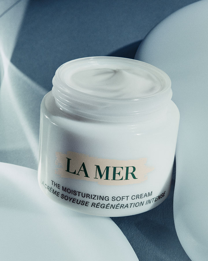 The Moisturizing Soft Cream with lid off showcasing product texture in a dramatically lit setting